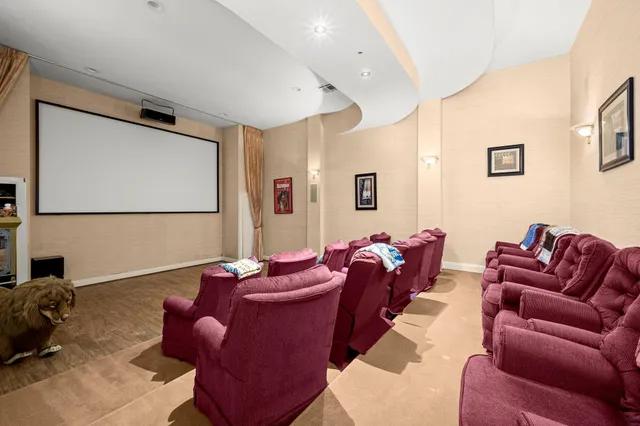 a room with lots of white furniture and rug