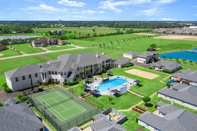 an aerial view of a house with outdoor space swimming pool and mountain view in back