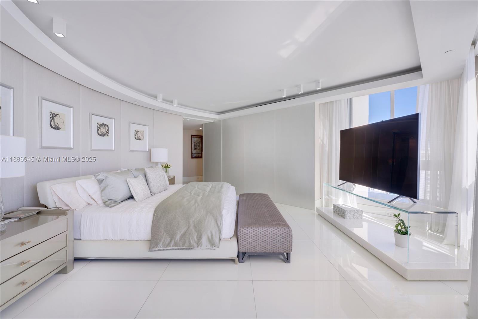 791 Crandon Boulevard, Unit 1408 Key Biscayne, FL 33149 - Photo 19 of 54 a living room with furniture and a flat screen tv