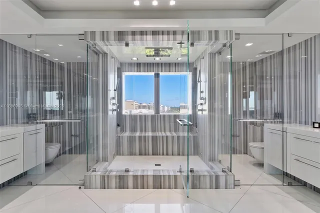 a bathroom with a tub shower and view of bathroom