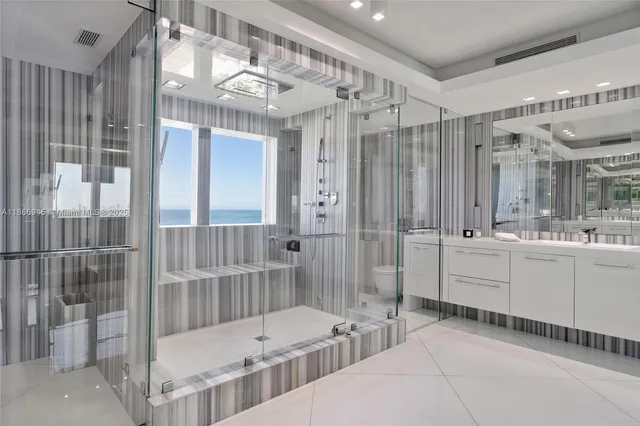 a bathroom with a tub sink shower and mirror