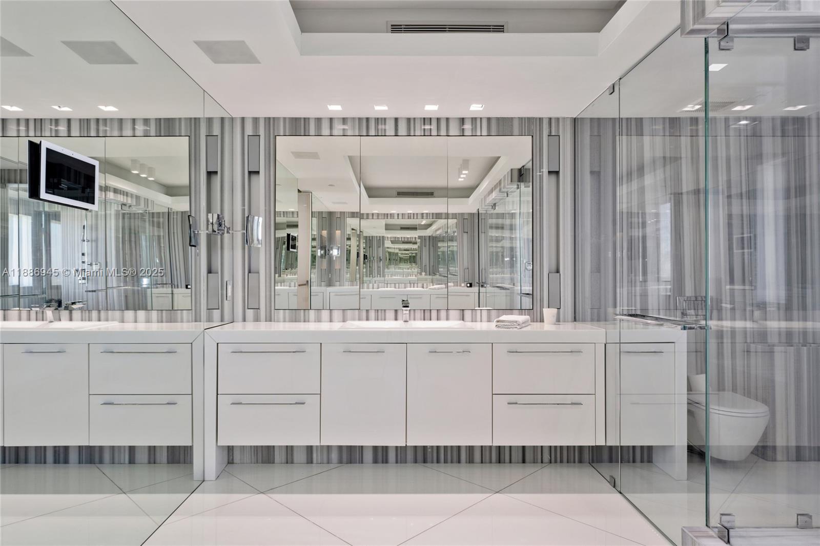791 Crandon Boulevard, Unit 1408 Key Biscayne, FL 33149 - Photo 22 of 54 a kitchen with stainless steel appliances kitchen island granite countertop a table and chairs