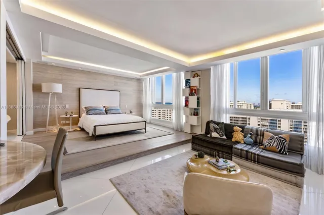 a bedroom with furniture and large windows