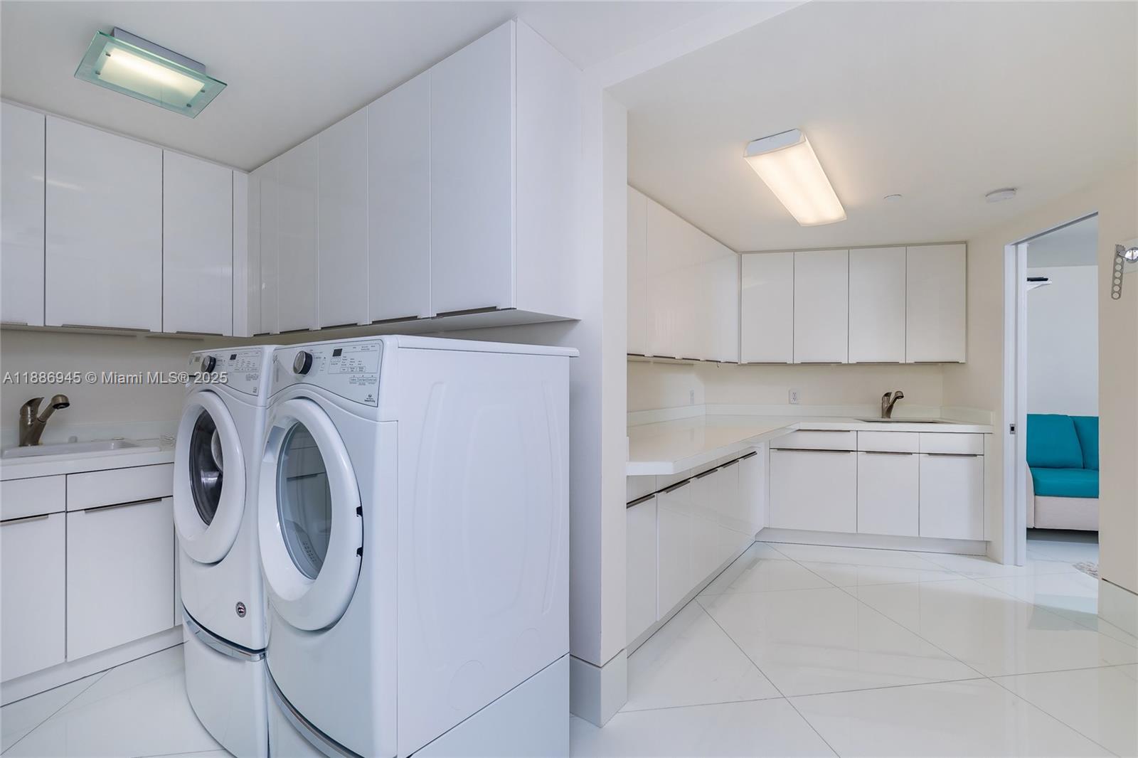 791 Crandon Boulevard, Unit 1408 Key Biscayne, FL 33149 - Photo 27 of 54 a utility room with cabinets washer and dryer