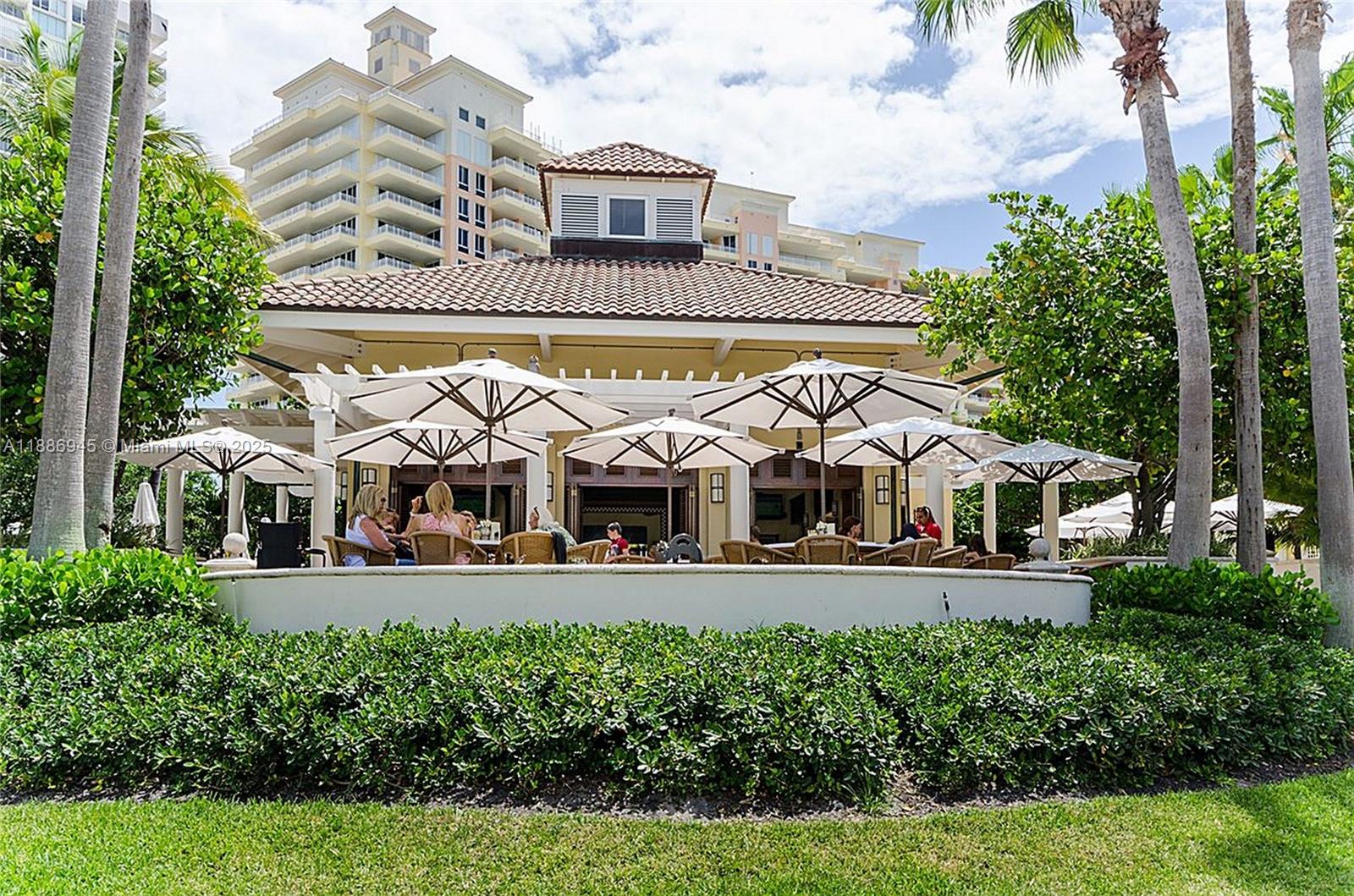 791 Crandon Boulevard, Unit 1408 Key Biscayne, FL 33149 - Photo 32 of 54 front view of a house with a garden