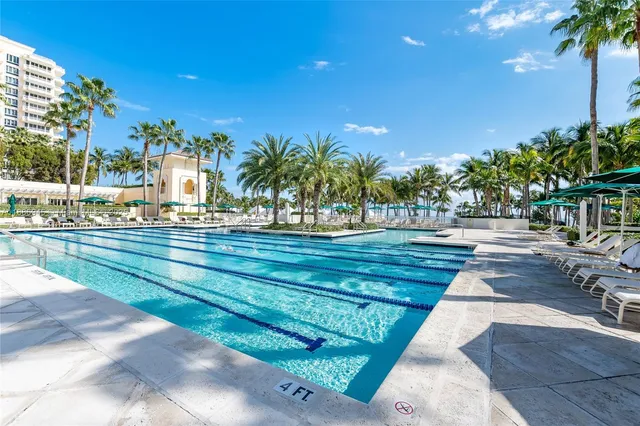 a view of swimming pool with outdoor seating and plants