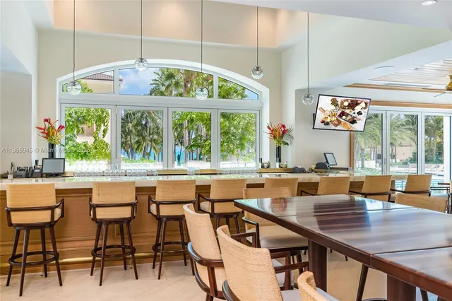a view of a dining room and livingroom with furniture wooden floor a chandelier