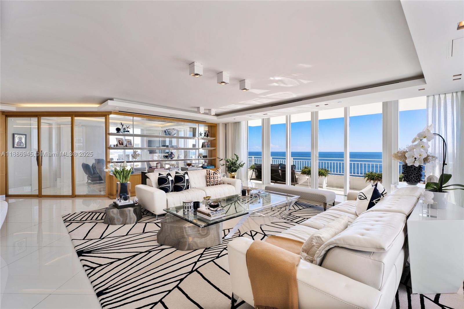 791 Crandon Boulevard, Unit 1408 Key Biscayne, FL 33149 - Photo 6 of 54 a living room with furniture large windows and wooden floor