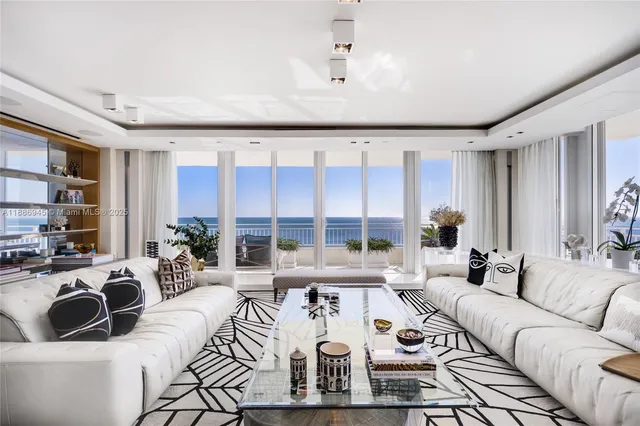 a living room with furniture large window and rug