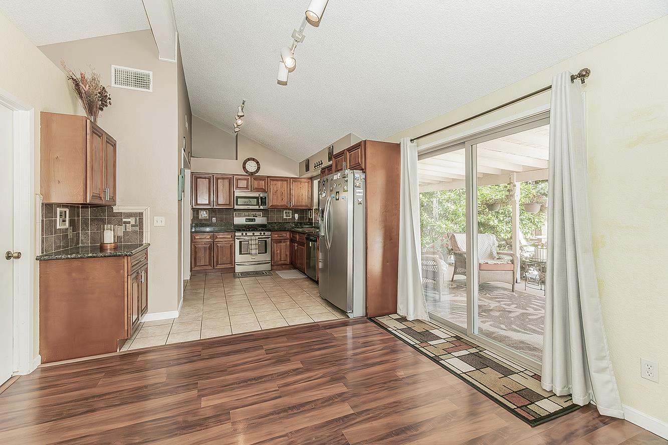 1908 East Niles Avenue Fresno, CA 93720 - Photo 10 of 30 a view of a kitchen with refrigerator and wooden floor