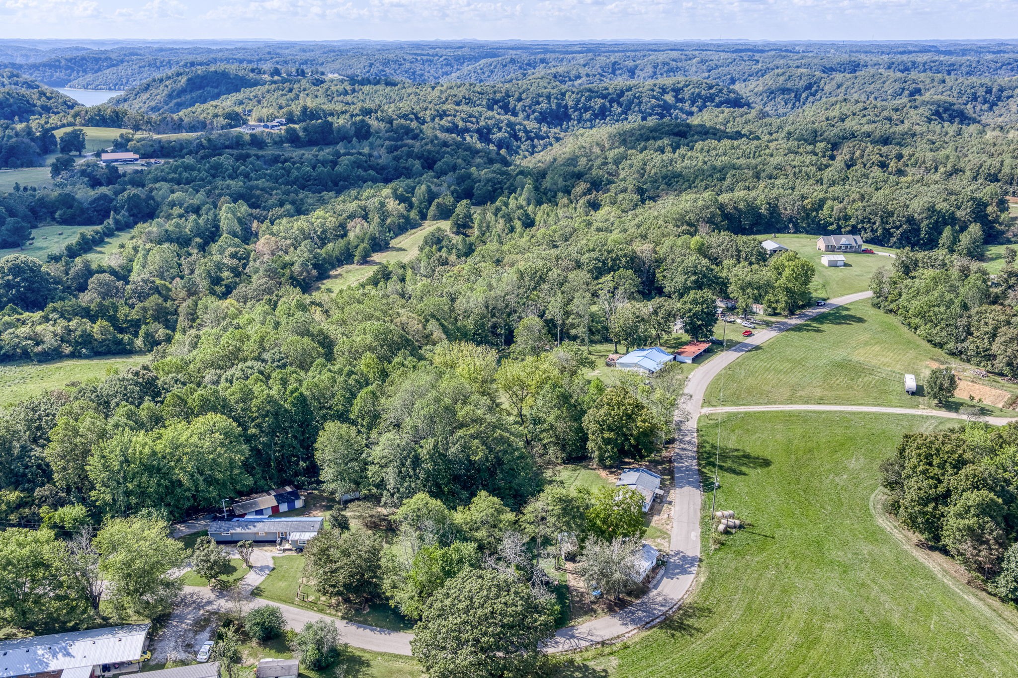 7331 Ashburn Road Baxter, TN 38544 - Photo 31 of 62 an aerial view of a houses with a lush green hillside