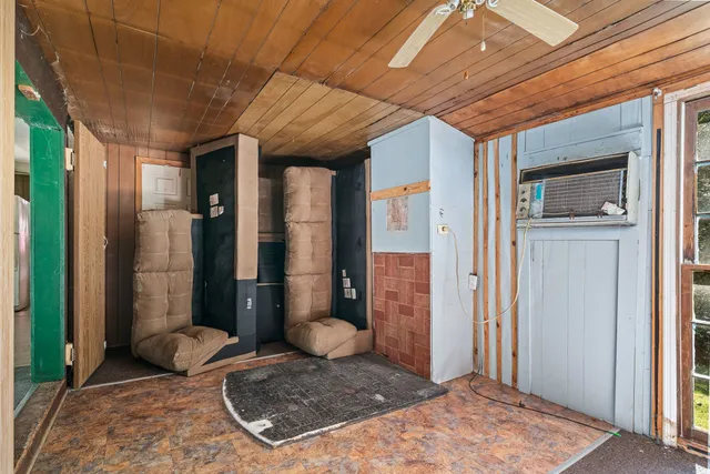 a view of a chair and table in backyard of the house