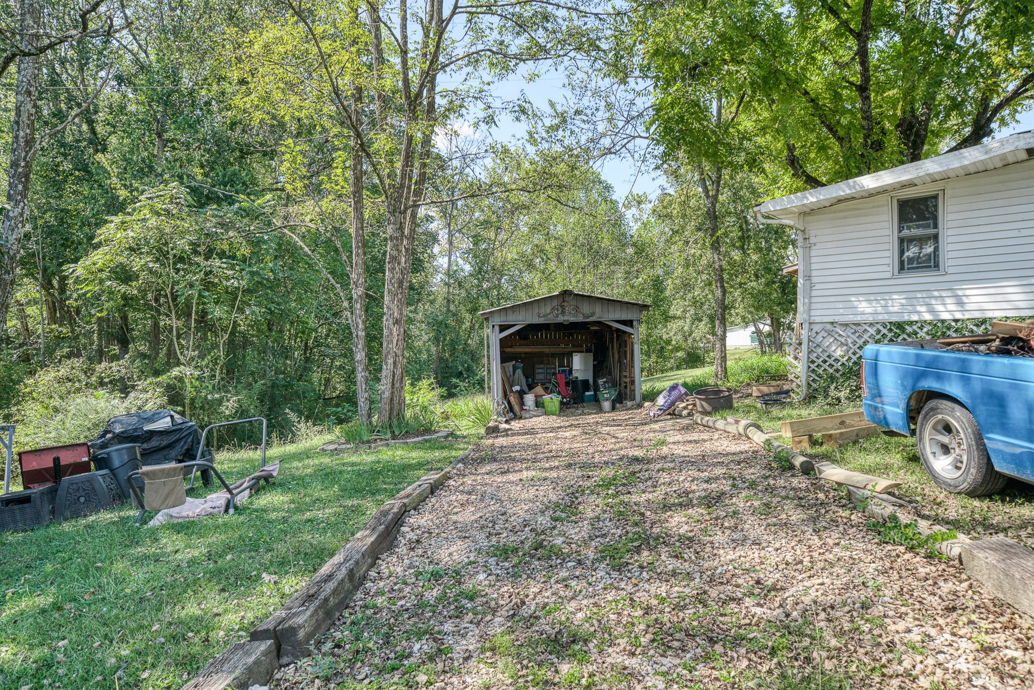 7331 Ashburn Road Baxter, TN 38544 - Photo 60 of 62 a front view of a house with garden and trees