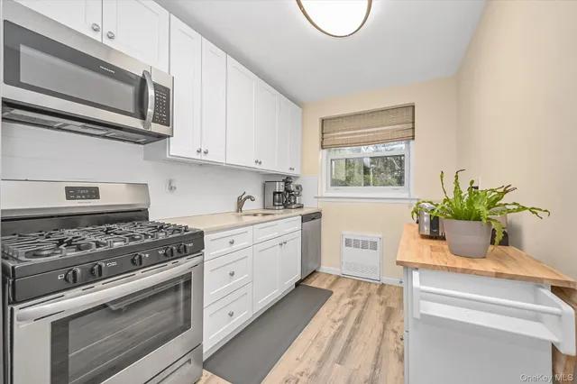 a kitchen with a stove a sink and a microwave