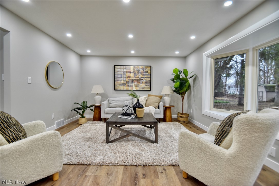 7520 Johnnycake Ridge Road Mentor, OH 44060 - Photo 18 of 36 Living room with a healthy amount of sunlight and light hardwood / wood-style flooring