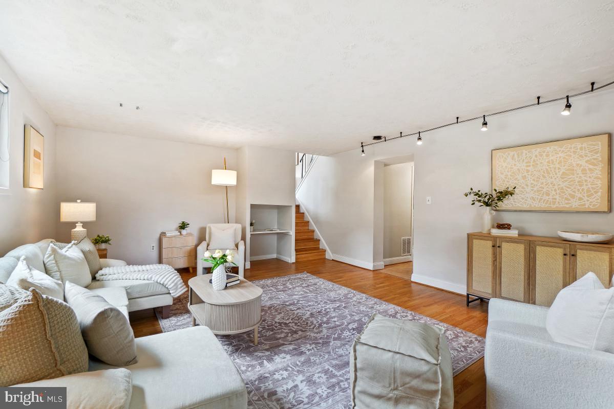 827 Caddington Avenue Silver Spring, MD 20901 - Photo 33 of 45 a living room with furniture and a wooden floor