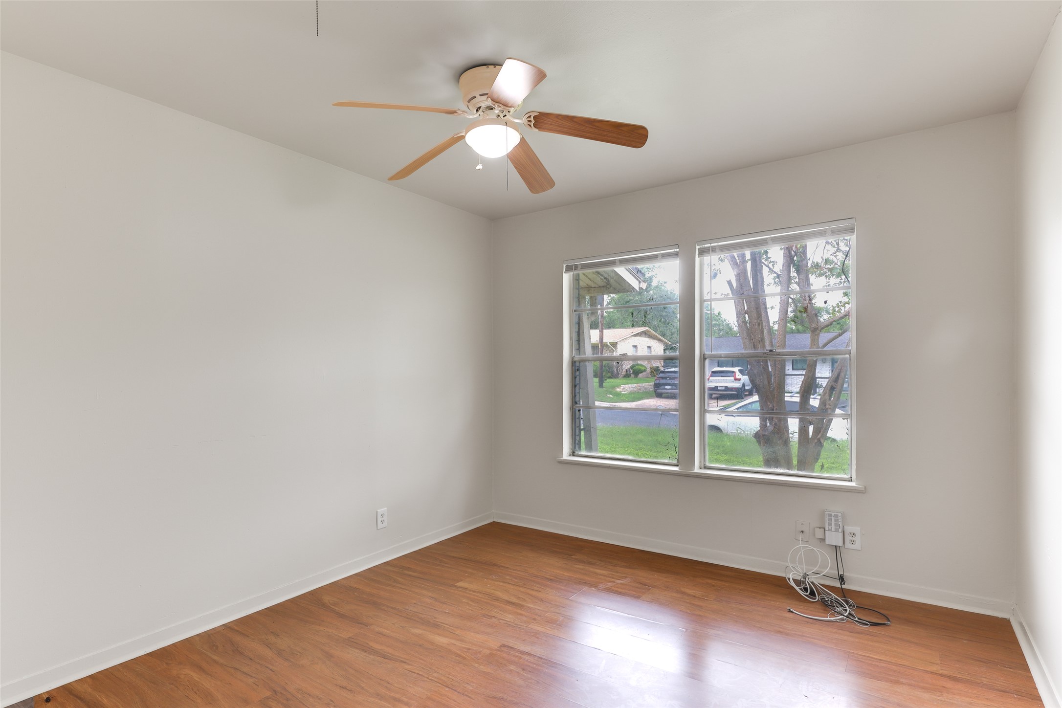 1800 Rhodes Road Austin, TX 78721 - Photo 10 of 14 an empty room with window and ceiling fan