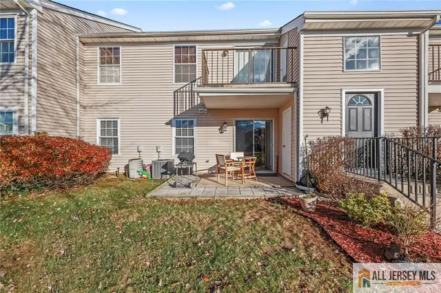 a view of a house with backyard and sitting area