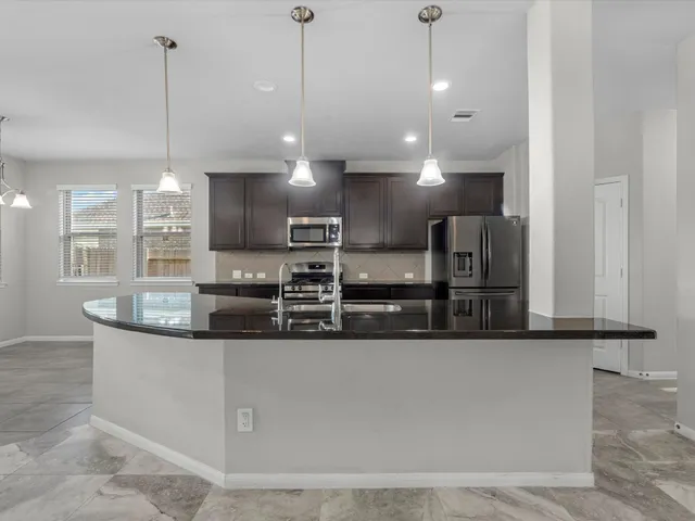 a large kitchen with kitchen island a large island in the center