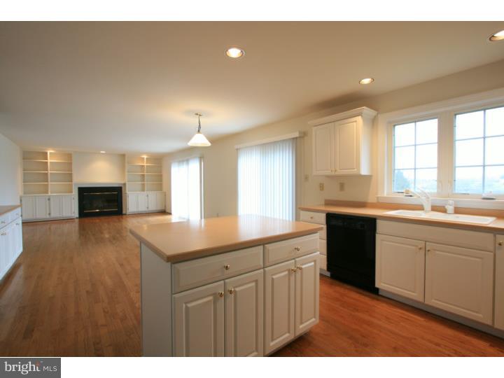 630 East Hillendale Road Chadds Ford, PA 19317 - Photo 10 of 18 a kitchen with kitchen island a sink dishwasher a stove and a refrigerator with wooden floor