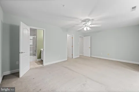 a view of an empty room with a ceiling fan