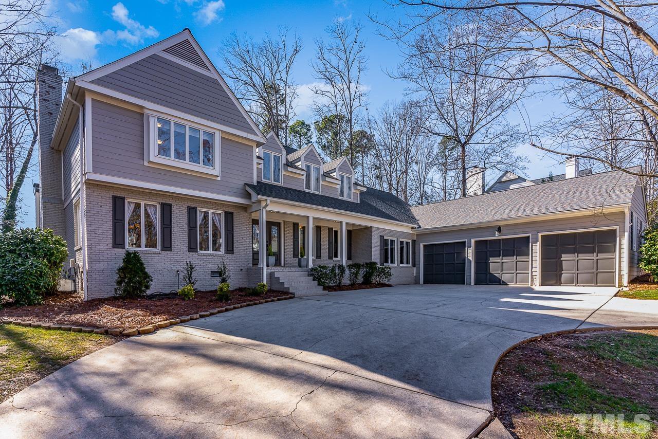 113 Bruce Drive Cary, NC 27511 - Photo 1 of 48 a front view of a house with a yard and potted plants