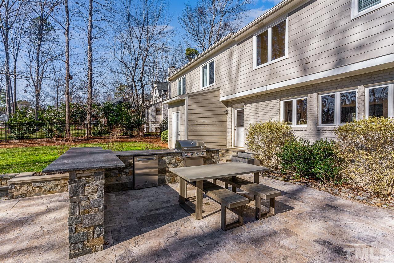 113 Bruce Drive Cary, NC 27511 - Photo 13 of 48 a backyard of a house with barbeque oven table and chairs