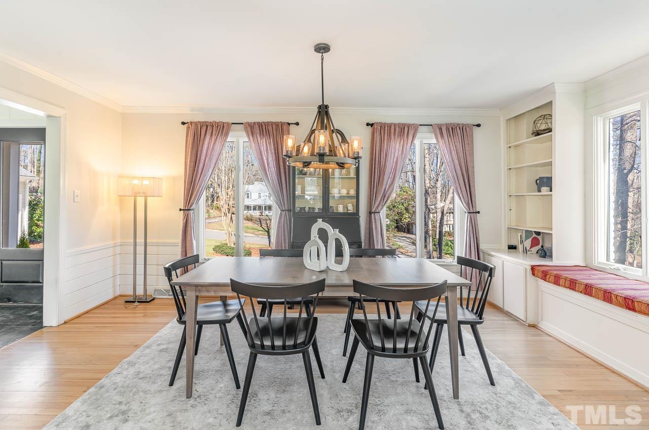 113 Bruce Drive Cary, NC 27511 - Photo 16 of 48 a dining room with furniture a chandelier and wooden floor