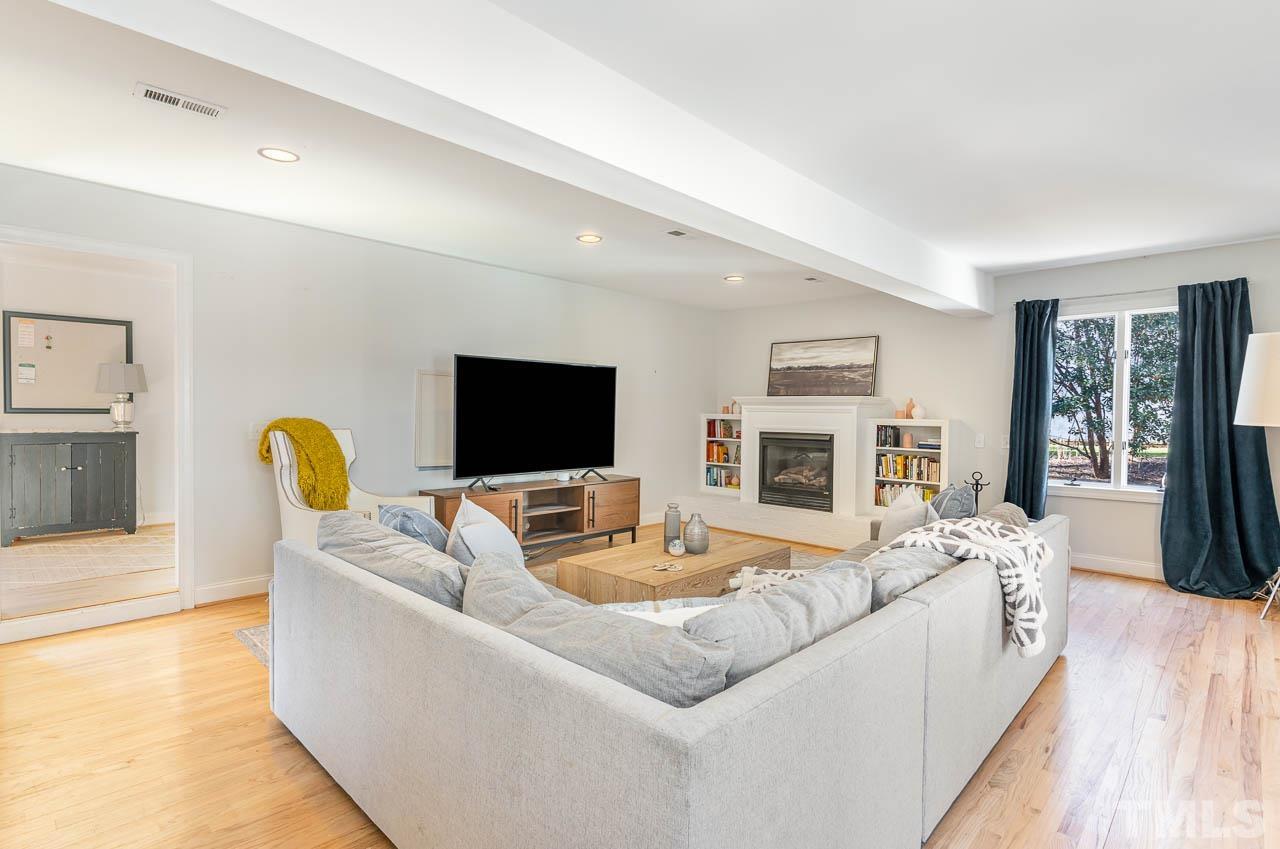113 Bruce Drive Cary, NC 27511 - Photo 28 of 48 a living room with furniture and a flat screen tv