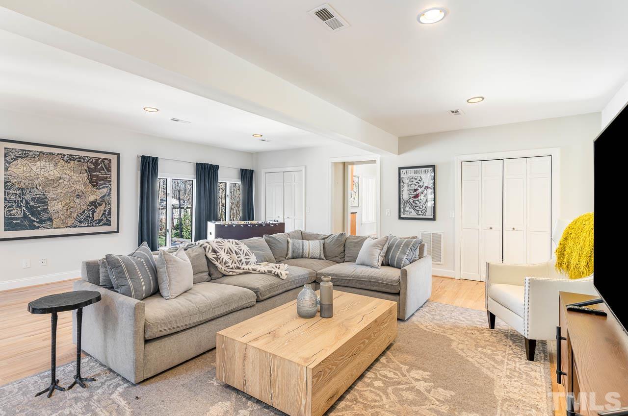 113 Bruce Drive Cary, NC 27511 - Photo 29 of 48 a living room with furniture and a flat screen tv