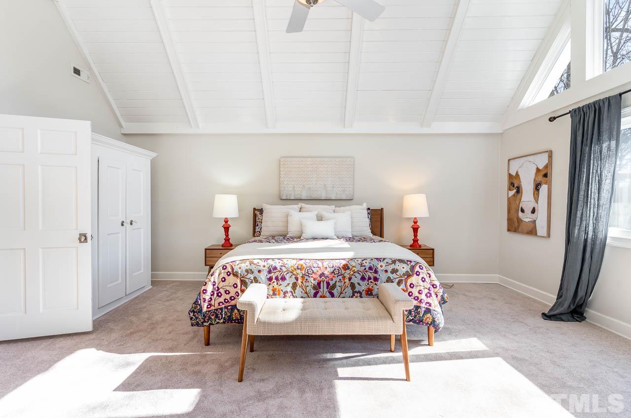 113 Bruce Drive Cary, NC 27511 - Photo 31 of 48 a bedroom with a bed and a mirror