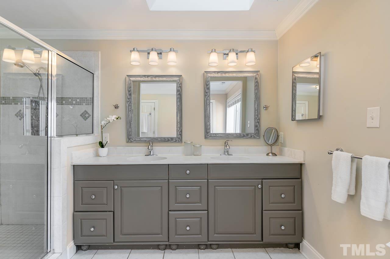 113 Bruce Drive Cary, NC 27511 - Photo 33 of 48 a bathroom with double sink and a mirror