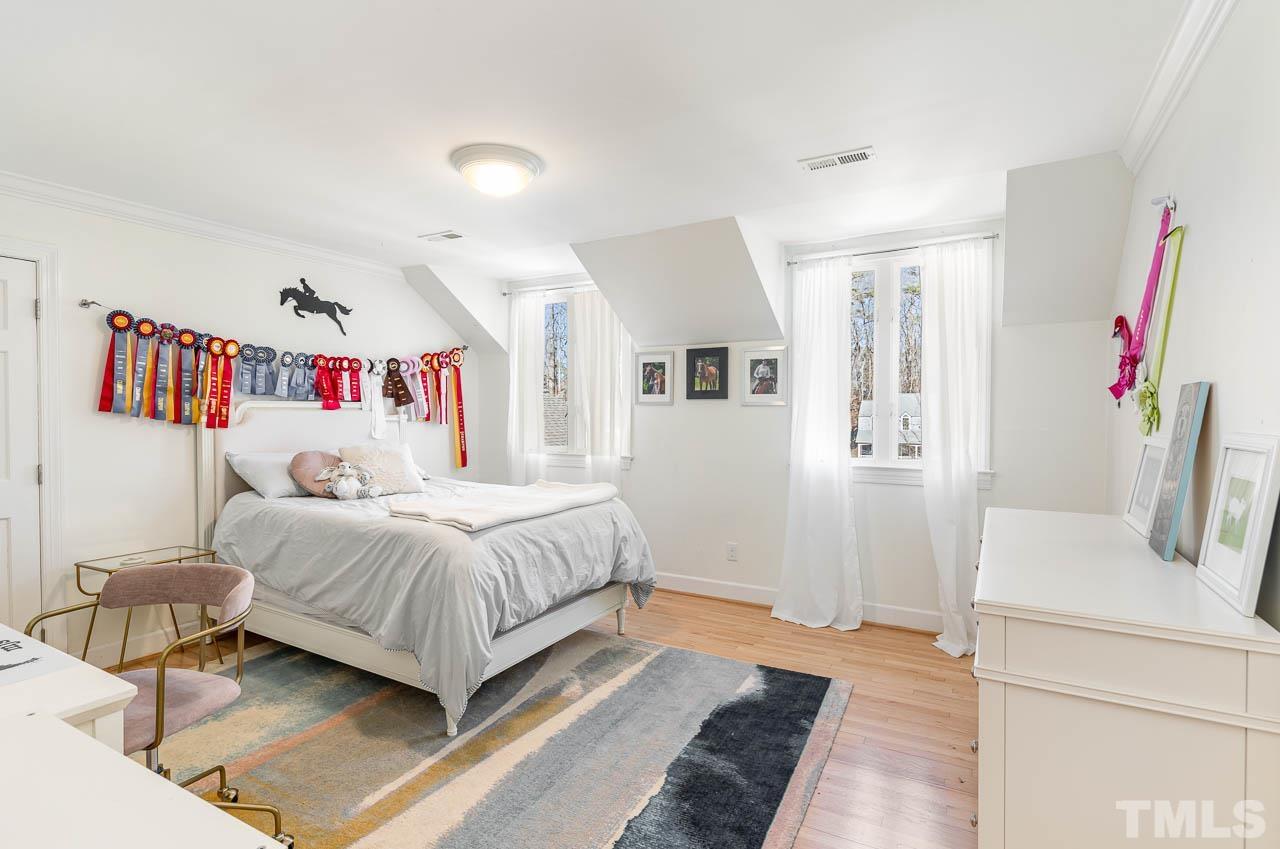 113 Bruce Drive Cary, NC 27511 - Photo 36 of 48 a bedroom with a bed and a large mirror