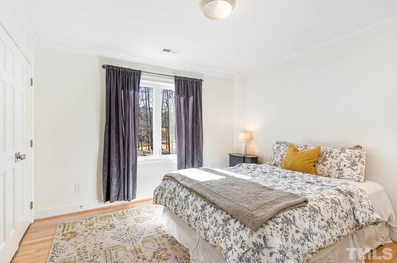 113 Bruce Drive Cary, NC 27511 - Photo 37 of 48 a bedroom with a large bed and a window