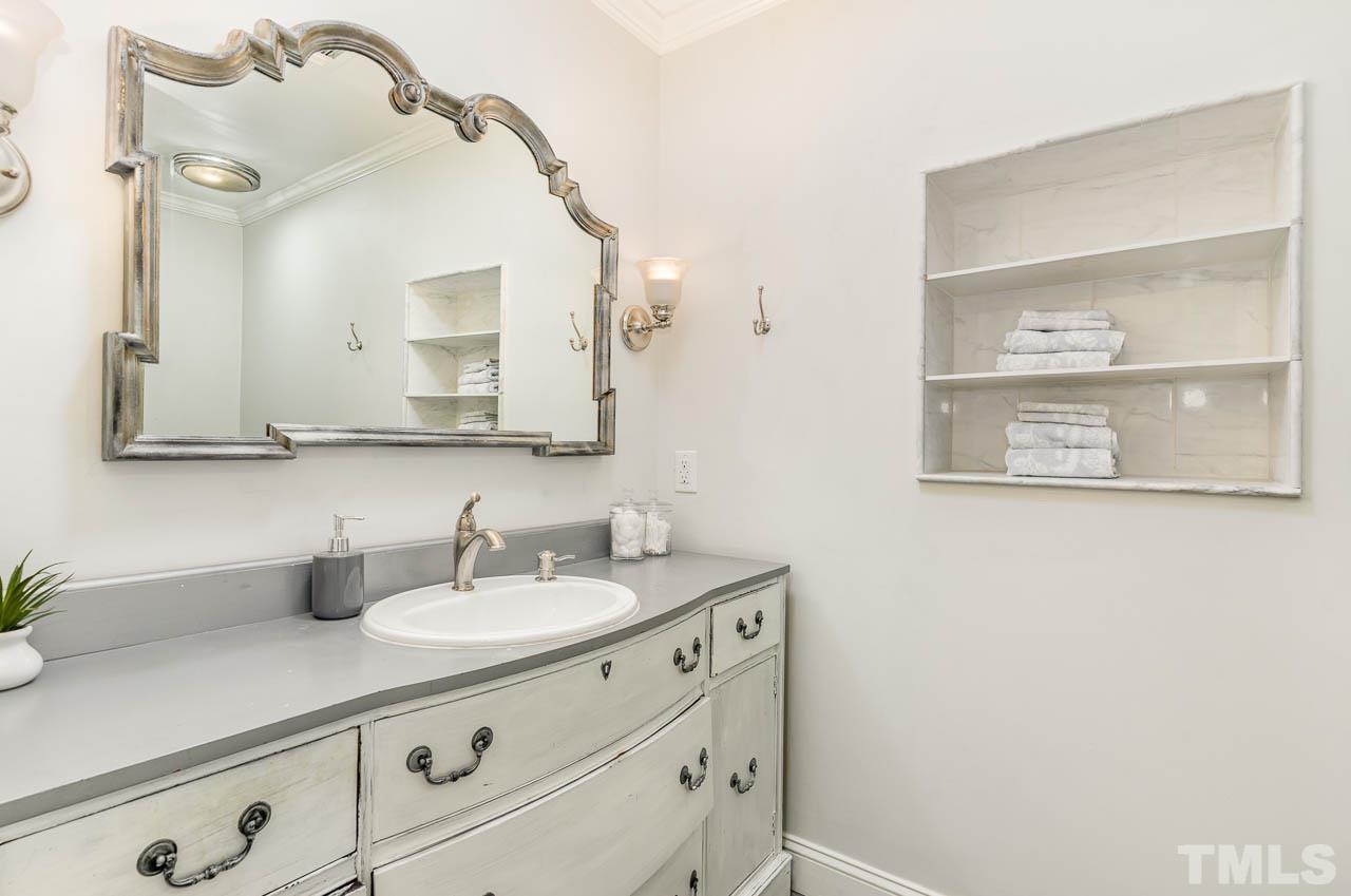 113 Bruce Drive Cary, NC 27511 - Photo 39 of 48 a bathroom with a sink and a mirror