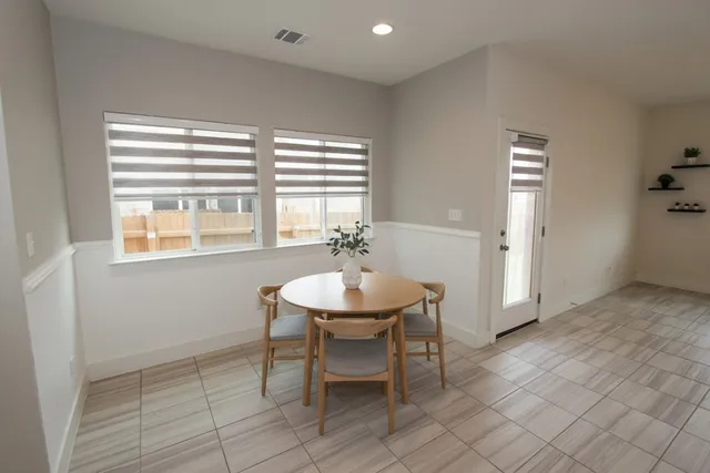 a dining room with furniture and window