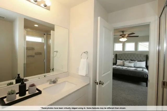 a en suite bathroom with a double vanity sink and mirror