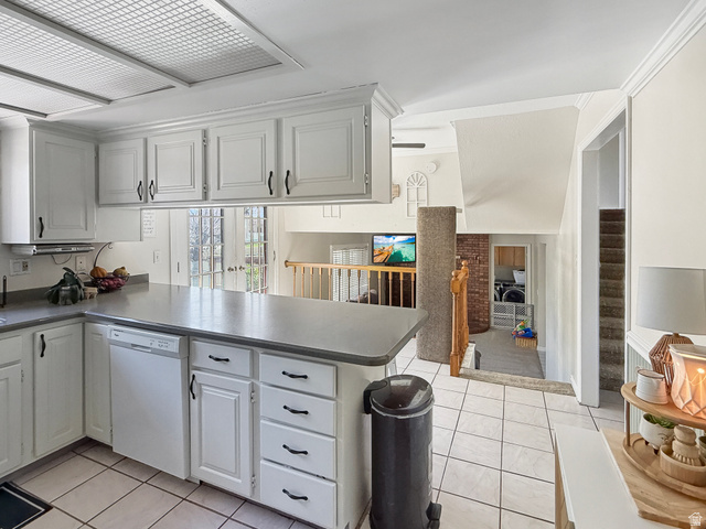 1716 Sagewood Road Price, UT 84501 - Photo 13 of 73 Kitchen featuring a peninsula, dishwasher, light tile patterned floors, white cabinets, and dark countertops