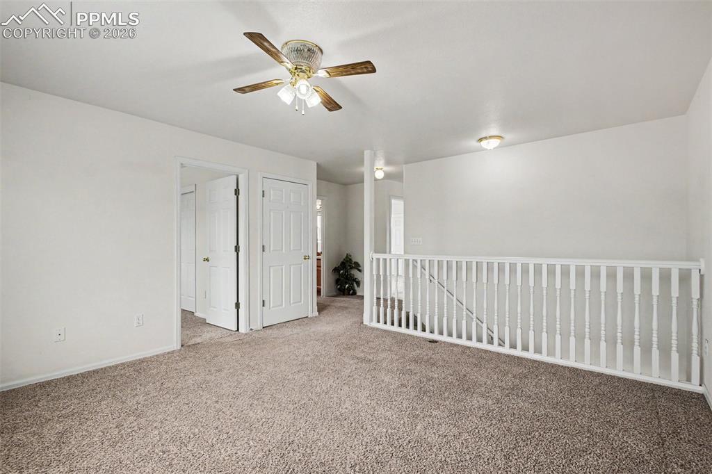 12210 Crystal Downs Road Peyton, CO 80831 - Photo 14 of 40 a view of a livingroom with a ceiling fan and entryway