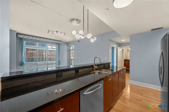 a living room with furniture and floor to ceiling windows