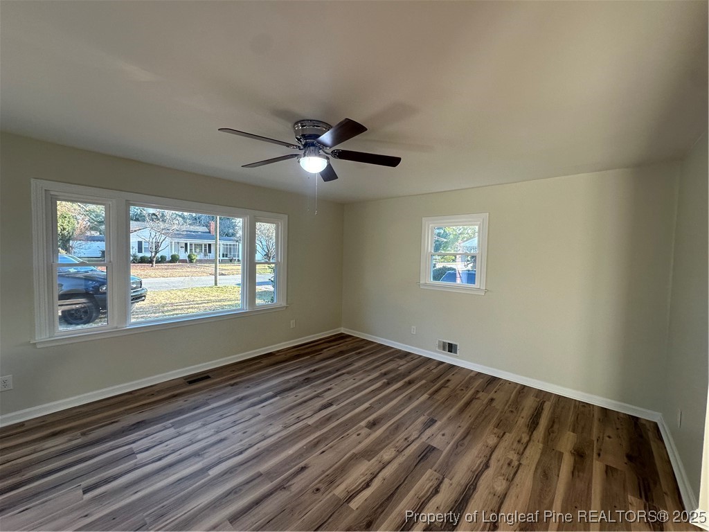 411 Lafayette Street Clinton, NC 28328 - Photo 16 of 24 wooden floor in an empty room with a window