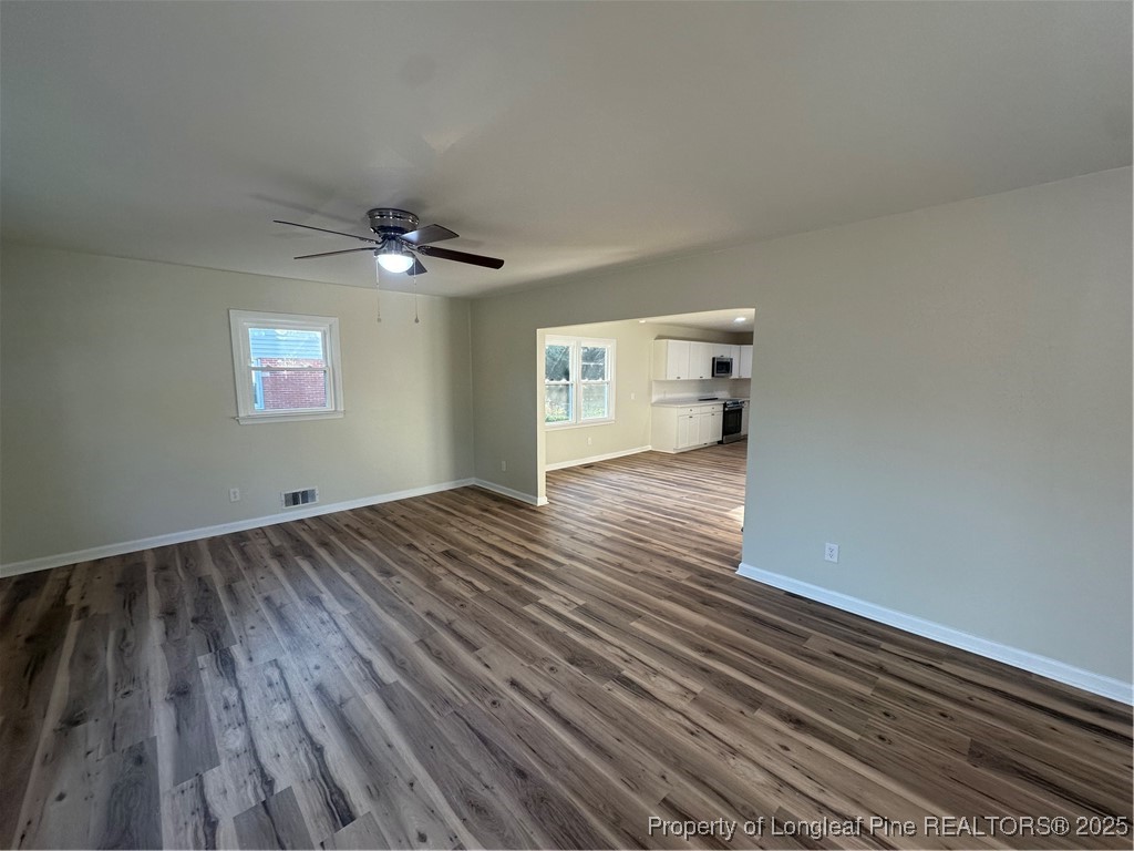 411 Lafayette Street Clinton, NC 28328 - Photo 17 of 24 wooden floor in an empty room with a window