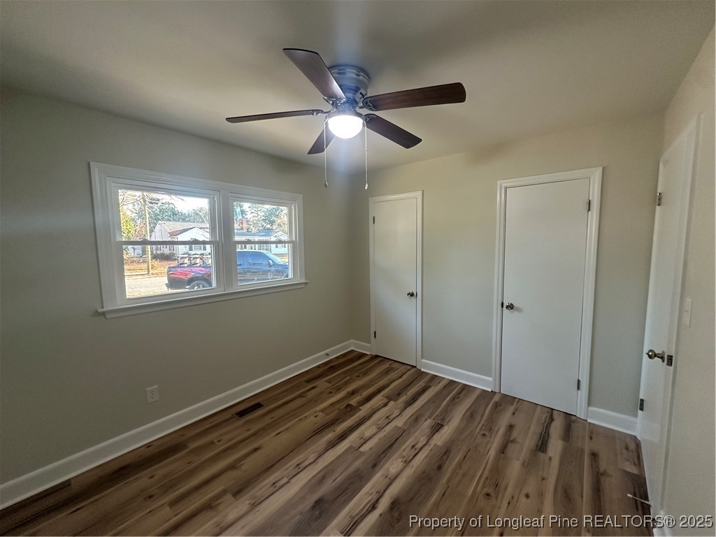 411 Lafayette Street Clinton, NC 28328 - Photo 18 of 24 a view of an empty room with window and wooden floor