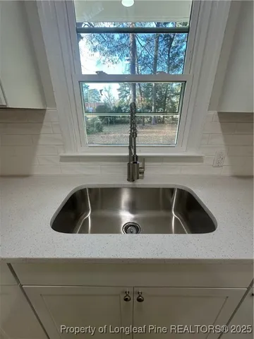 a kitchen with a sink and a window