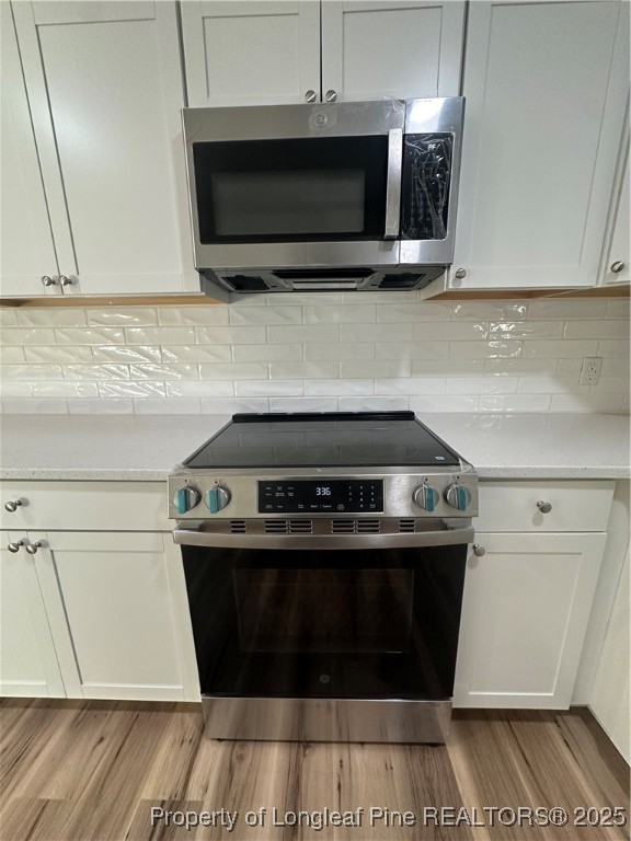 411 Lafayette Street Clinton, NC 28328 - Photo 7 of 24 a stove top oven sitting inside of a kitchen