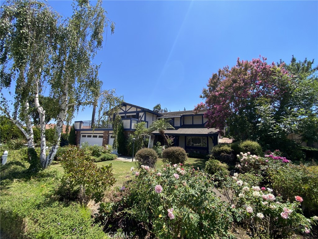 an aerial view of a house with yard and outdoor seating