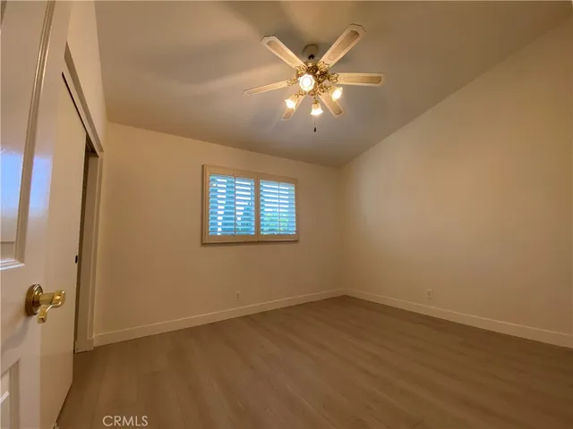 a view of a room with a window and a ceiling fan