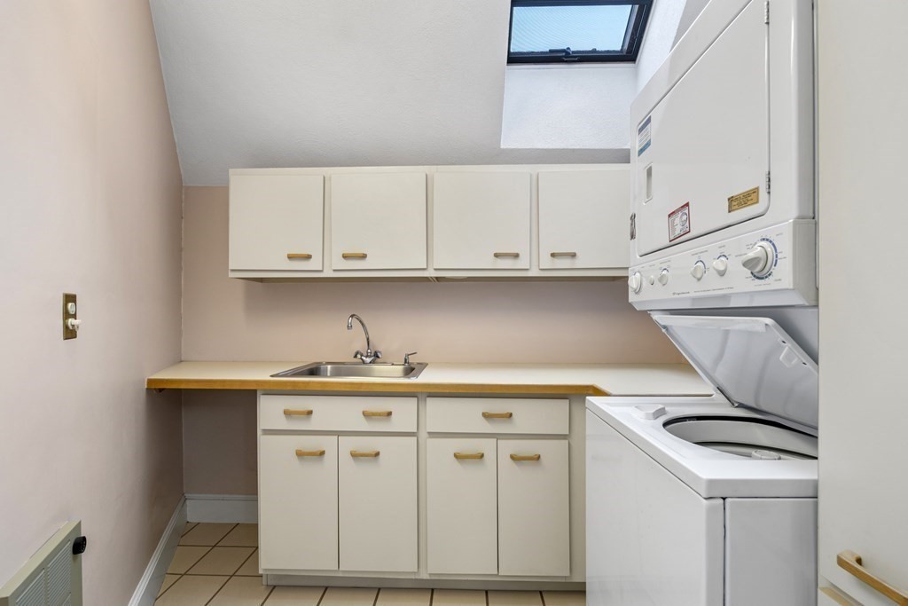 8 Edgemere Road Marblehead, MA 01945 - Photo 19 of 41 a kitchen with white cabinets and white appliances