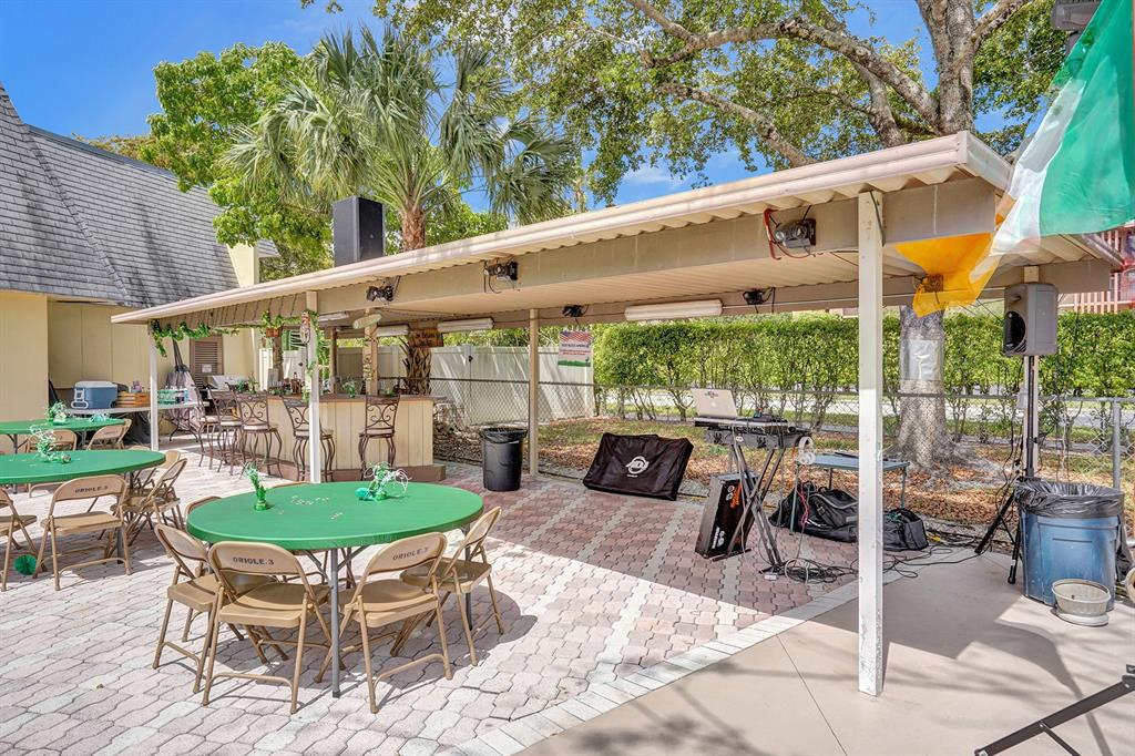 331 Northwest 76th Avenue, Unit 104 Margate, FL 33063 - Photo 24 of 30 a patio with table and chairs