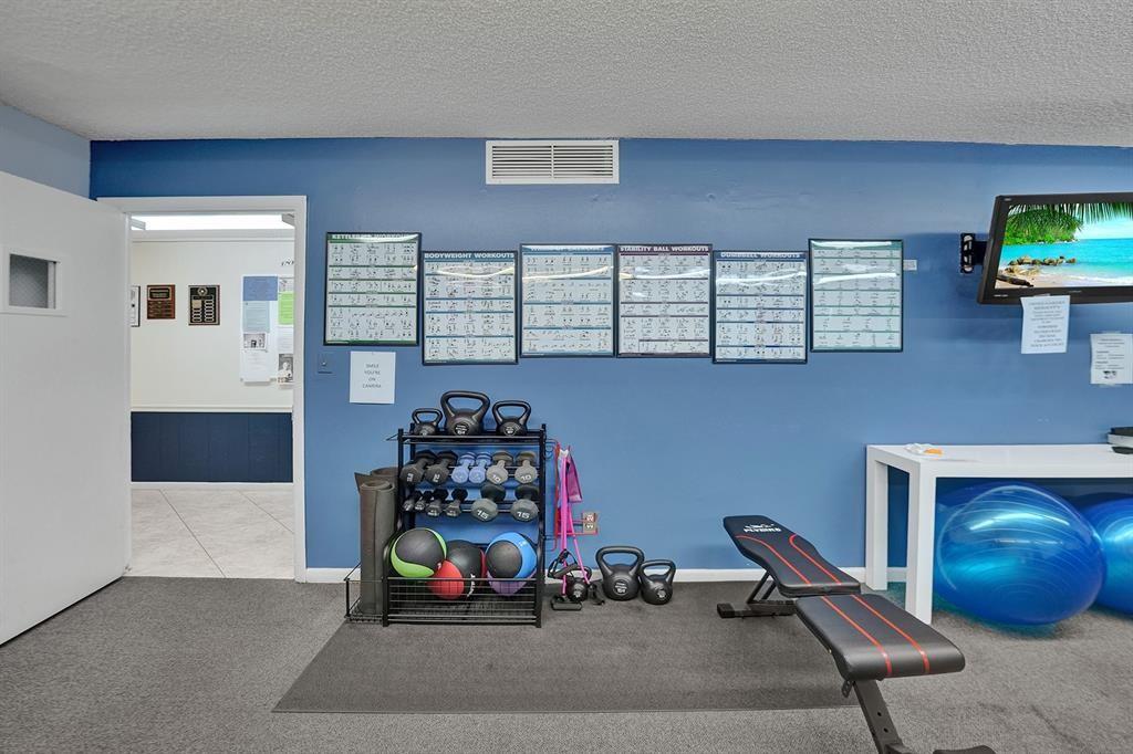 331 Northwest 76th Avenue, Unit 104 Margate, FL 33063 - Photo 25 of 30 a room with toys and a wooden floor